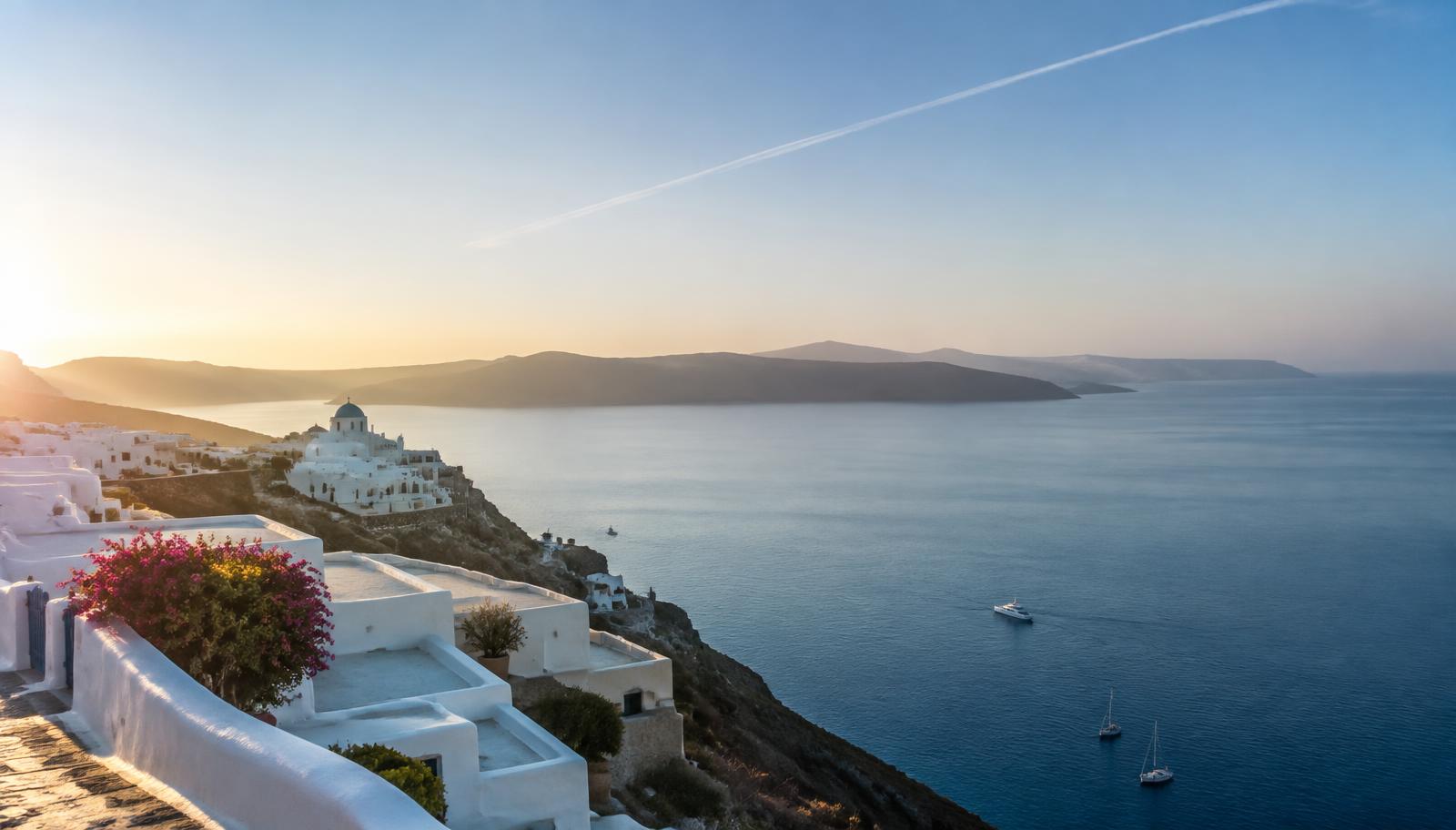 White coastal buildings overlooking the sea at sunset